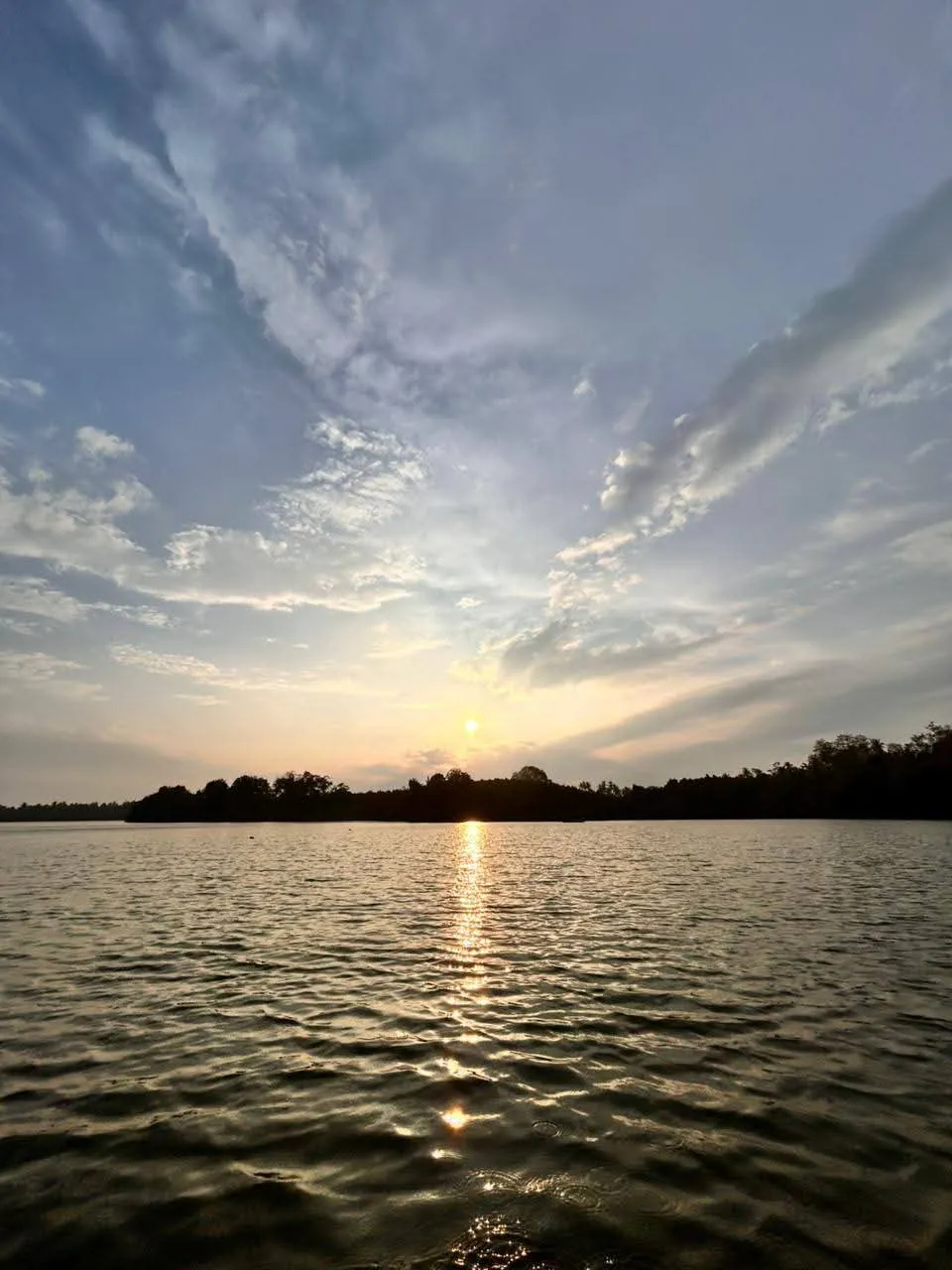 Golden sunset over Rathgama Lagoon with calm water reflections, Southern Sri Lanka