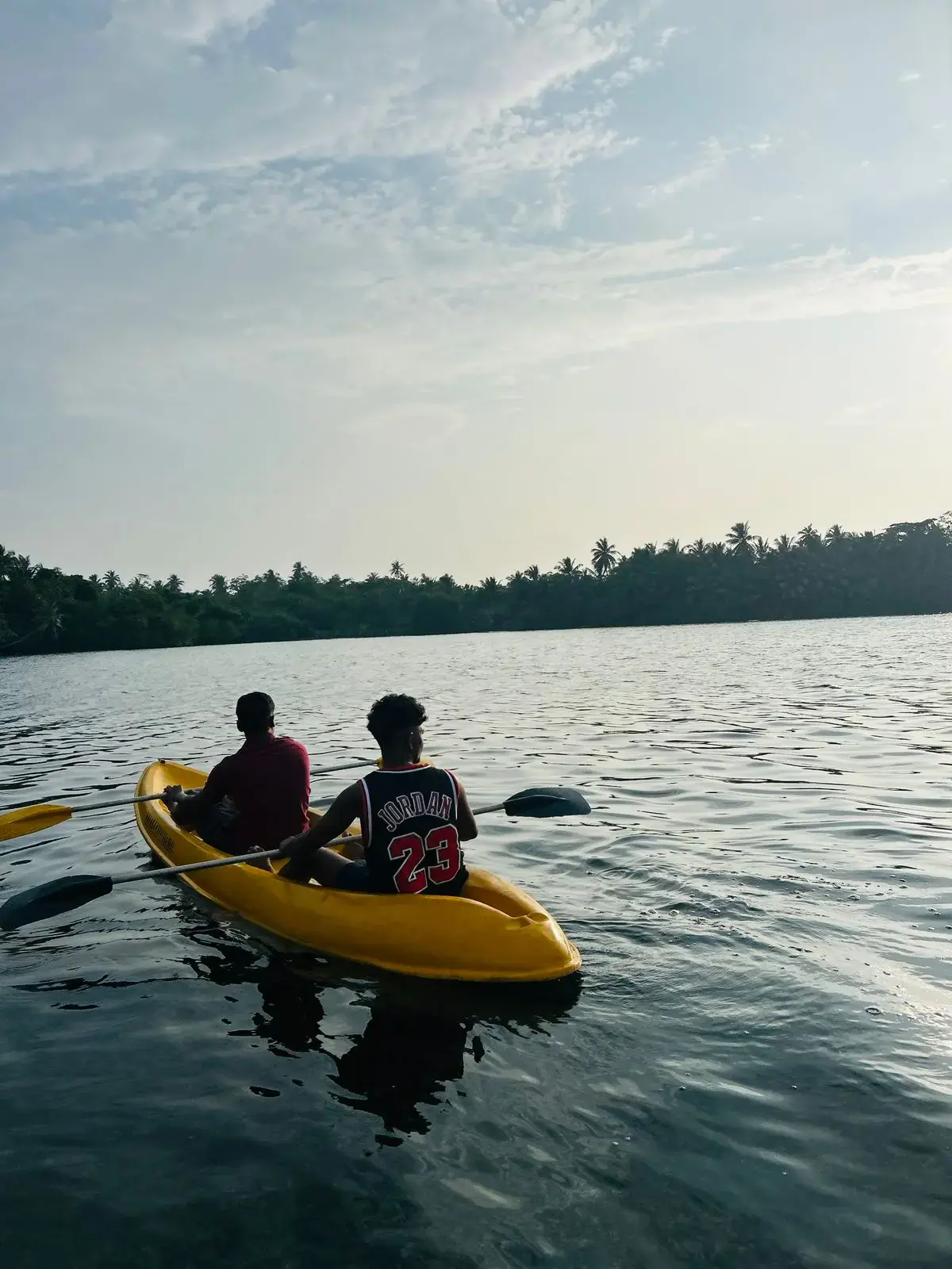 Kayaking in a yellow tandem kayak on the quiet Rathgama Lagoon, Sri Lanka