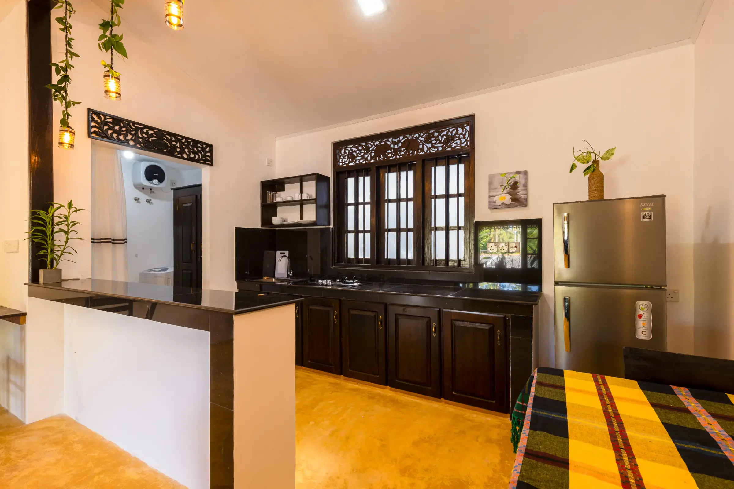 Fully equipped private kitchen with dark wood cabinets, granite breakfast bar at Serene Luxe Villa