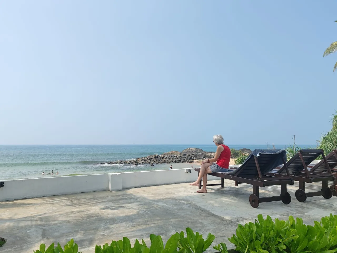 Beachfront garden with sunbeds and umbrellas at Villa One 64