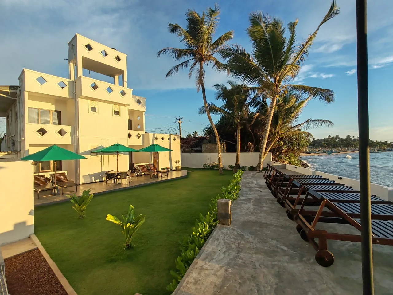 Villa One 64 Beachfront exterior with tropical garden and direct beach access