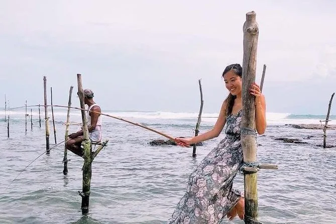 Silhouette of Sri Lankan stilt fishermen on wooden poles in the sea